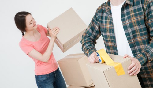 Removalists safely lifting furniture during a house move in Brompton