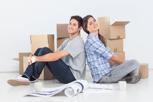 Movers transporting furniture through a Brompton property