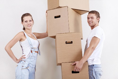 Movers loading household items during a same day removal in Brompton